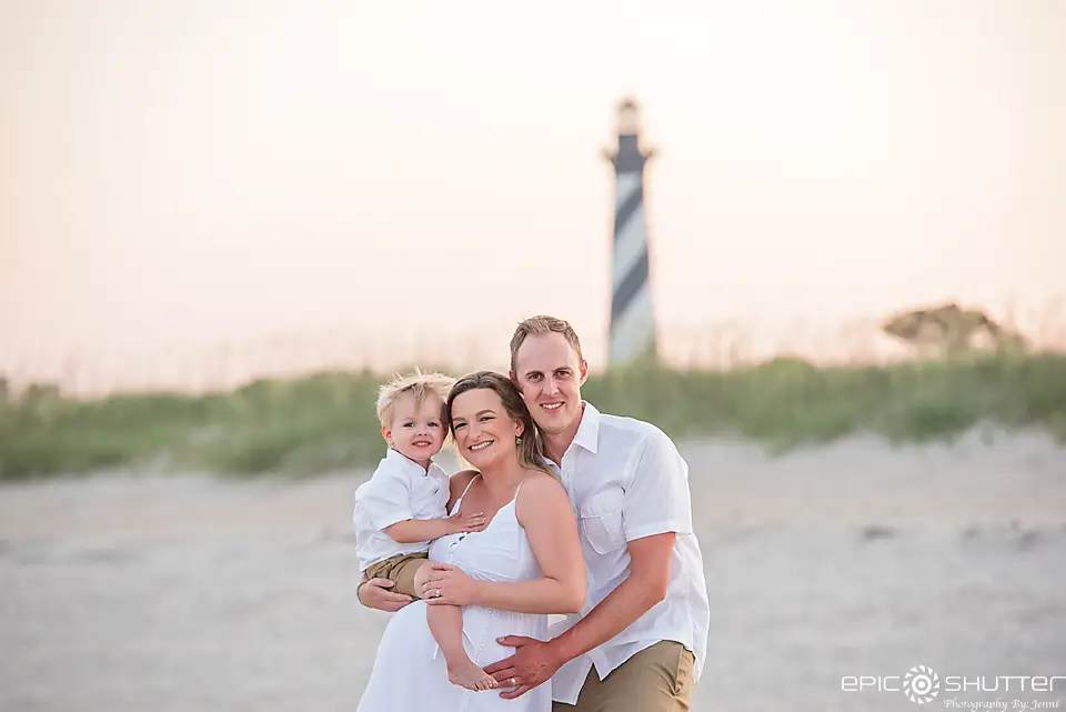 A family posing for the camera on the beach